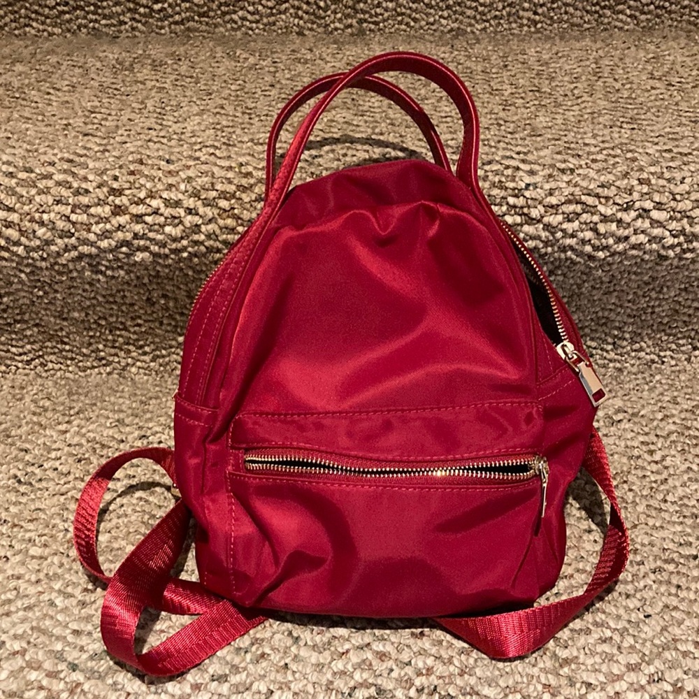Red nylon back pack with handles on top